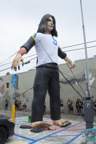 A 25-foot-tall Ozzy Osbourne balloon stands across the street from Fingerprints Music.