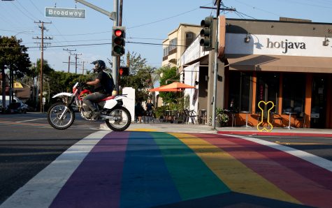 10/6/2022: Long Beach, CA- A motorcyclist passes through the rainbow colored crosswalk at the Broadway and Junipero intersection on Thursday afternoon in Long Beach.