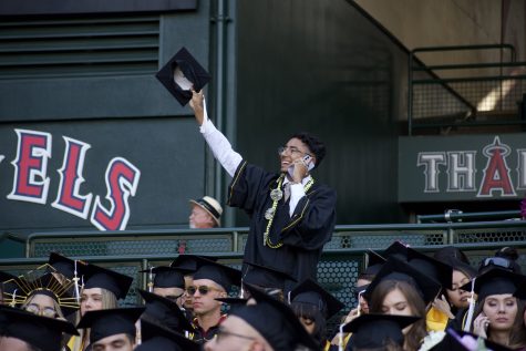 At the Angel Stadium, graduates sat in the stands after having a procession leading them to their seats.