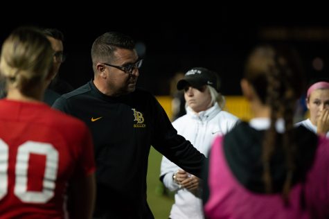 10/30/2022 - Long Beach, Calif: Long Beach State Women's soccer head coach, Mauricio Ingrassia, coaches his team in the huddle before the overtime period begins against UC Santa Barbara on Sunday at George Allen Field.