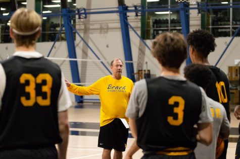 Long Beach State Men's basketball head coach, Dan Monson, leads and tells his team and son, Maddox Monson (No. 3), what he expects of them for this upcoming season during Monday's practice inside the Walter Pyramid.