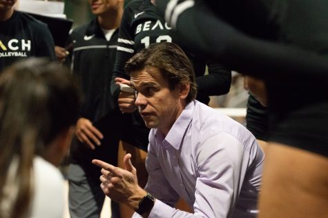 10/01/2022 - Long Beach, Calif: Long Beach State Women's volleyball head coach, Tyler Hildebrand, leads his team in a huddle during timeout during the Beach's game against Hawai'i on Saturday inside the Walter Pyramid.