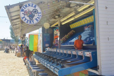Water bullseye is one of the many popular children's game booths available at the pumpkin patch.