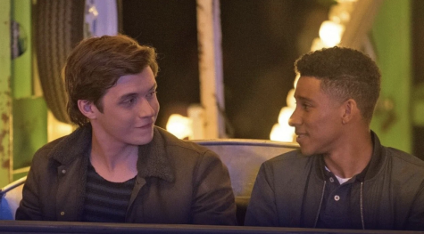 Scene from Love, Simon of the two teen male protagonists looking at each other romantically while on a ferris wheel.