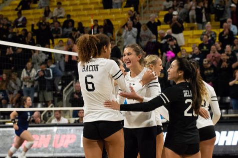 10/15/2022 - Long Beach, Calif: Long Beach State Women's Volleyball players Kameron Bacon (left), Zayna Meyer (middle), and Dylan Dela Cruz (right), share a moment of gladness and praise for each other during their matchup against UC Irvine on Saturday.