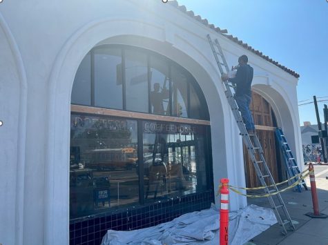 Former building of Portfolio Coffeehouse is repainted by a worker.