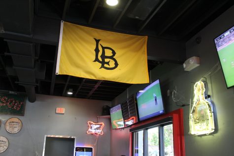 A CSULB flag hangs inside Dogz Bar and Grill.