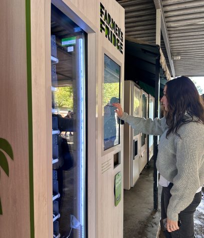 Graduate student, Abby Lanigan, scrolls through the many options that the Farmers Fridge vending machine offers.