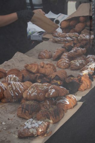Pastries were sold at the farmers market. Almond custard, chocolate, and plain buttered croissants were included.