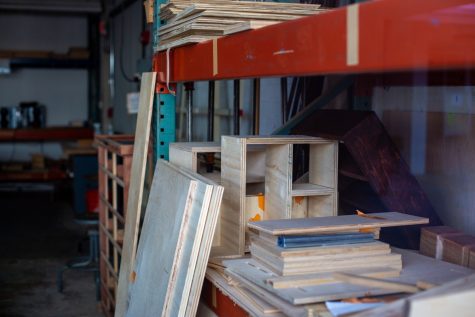 Student projects and supplies sit inside a fine arts wood shop on campus. Some of these projects are for an end-of-semester assignment in Art 121, Safety and Sustainable Practices for Studio Artists.