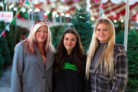 Tracy Todd and her daughters Americus and Tiffany (in order from left to right) pose for a photo in front of the Christmas tree lot.