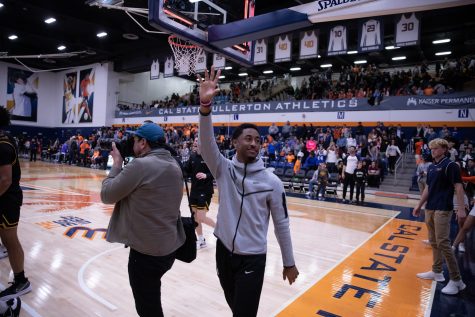 02/02/23: Long Beach, CA- CSUF fans leave the Titan Gym as LBSU freshman guard Jason Hart Jr. waves goodbye to the opposing team's fans after sweeping CSUF in the regular season.