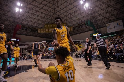02/09/2023: Long Beach, CA- Sportsmanship on display as LBSU sophomore forward Aboubacar Traore helps his teammate redshirt freshman guard AJ George up from the ground during The Beach's loss to UCSB at home on Thursday night.