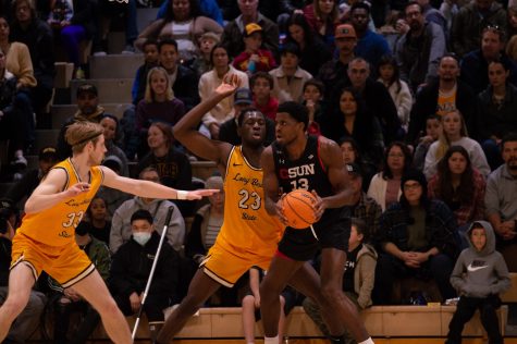 02/25/2023 - Long Beach, Calif: LBSU men's basketball player, Lassina Traore (#23), defends CSUN's Onyi Eyisi with (#13) with the help from Tobias Rotegaard (#33) inside the Gold Mine.