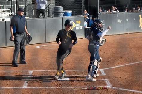 02/12/2023 - Long Beach, Calif: LBSU softball catcher, Teah Thies, gets to home to score a run for the Beach's one and only run in the first of two games against the University of San Diego.