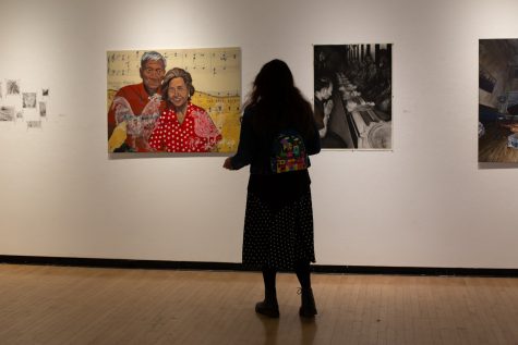 A student views the works of Steffany Maybel Reyes, Alfred Camacho, Elie Vadakan, and Hongtian Liu (pictured left to right).