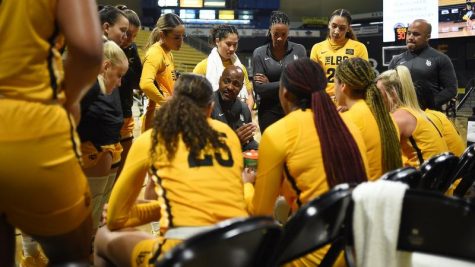 LBSU women's basketball head coach, Jeff Cammon leads a huddle during a timeout. to talk strategy. Cammon takes great pride in his job and who he is as a person.