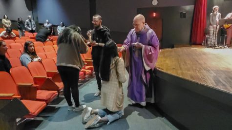 Priests mark ashes on congregation members' foreheads as part of the Ash Wednesday mass at CSULB.