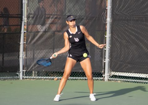 Junior Sarah Medik smashes the tennis ball in her heated singles match versus Boston.