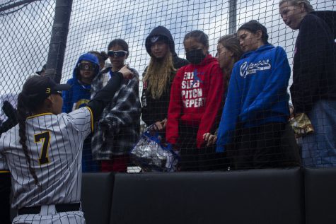 LBSU softball freshman infielder Selena Perez interacting with young softball fans at the LBSU softball complex.