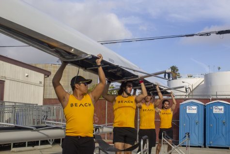 LBSU rowing novice crew carrying their four-seat boat at the USC Boathouse on Saturday April 8, 2023.