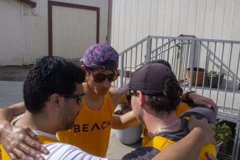 Rowing club president Ronald Reyes (center) coming together with his veteran crew after losing their four-man race at the USC Boathouse on Saturday April 8, 2023.