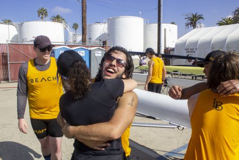 Novice rowing captain Alejandro Juarez hugging rowing coxswain Emaela Talavera Valdez at the USC Boathouse on Saturday April 8, 2023. Juarez and his crew placed second in the four-man novice race against USC and SDSU.