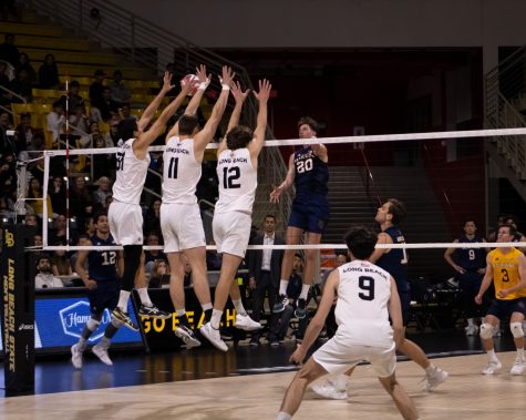 04/14/2023 - Long Beach, Calif : The Beach Volleyball team uses a triple block to wall up a spike from a UC Irvine Player. LBSU finishes with 10 total blocks.
