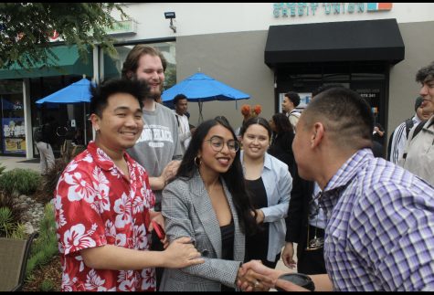 Jain shakes hands with students after being elected ASI President.