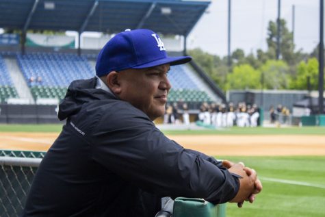 Before the game between the Long Beach State Dirtbags and Cal State Northridge Matadors, Rene Garcia debated on what cap he should wear to the field. He chose a neutral blue Dodgers cap.