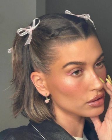 Hair ribbons are the perfect accessory for the summer. Hailey Bieber's take on hair ribbons pushes her hair out of her face, making it practical to beat the heat!