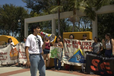 Long Beach 8/30 Third-year communications major Luis Ortiz speaks to protesters in front of the Go Beach sign near Brotman Hall