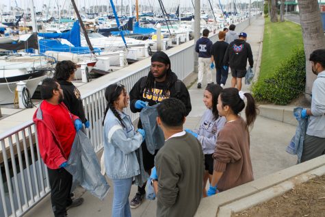 09/23/23 LONG BEACH, CALIF: Large groups of young volunteers gathered in the first hour of Costal Cleanup to start working on the docks at Seal Beach Yacht club.