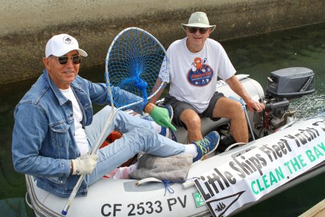 09/23/23 LONG BEACH, CALIF: Friends Hap (left) and Moti (right) ride a digny to collect trash along the docks Saturday morning. The men represent the Little Shops Yacht Club and Navy Yacht Club in Long Beach.