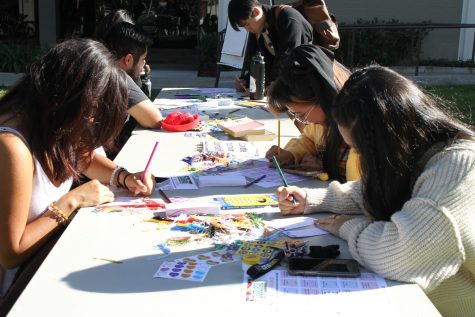 An activity table is set up for students to craft, make zen gardens and fill in Bingo cards in exchange for Asian cuisin at the crafting table. The students also placed messages on the Chinese "wishing tree" during the Sept. 13 Asian/Asian American Welcome day at the USU North Lawn.
