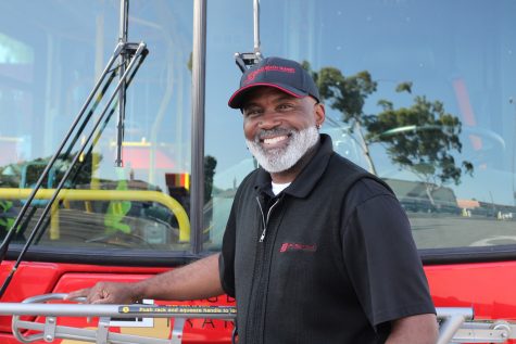 09/06/2023 - Long Beach, Calif: Arthur Mitchell poses at the front of the Long Beach Transit bus as he holds the bike rails on the front. Michell wakes up at 2 a.m. and brings his coffee to get ready for his long shift.