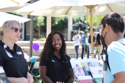 09/14/2023 - Long Beach, Calif: Misty Christman and Ashley King, who are two representatives for the California Baptist University booth, talk to a student about their program during the job fair.