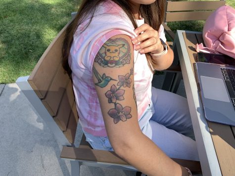 09/12/2023 - Long Beach, Calif: CSULB student Jennifer Diaz shows off her arm tattoos featuring a Pikachu tattoo, a Hummingbird tattoo and a roses tattoo.