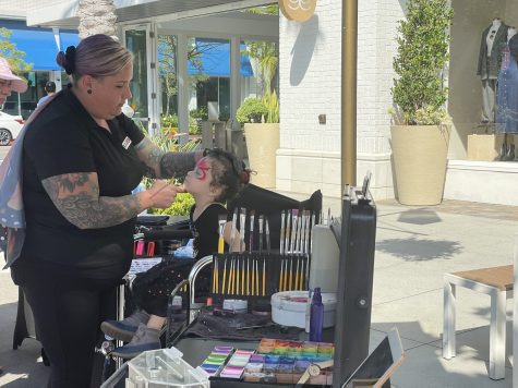 10/22/2023 - Long Beach, Calif.: Karen Nagh was hard at work at her face painting booth. Karen's Face Painting had a constant line of customers waiting to get their faces painted with a design of their choice.