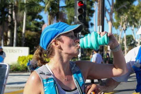 10/15/23 LONG BEACH, CALIF: Kristen Detrick takes a quick water break with her husband Nick during the marathon.