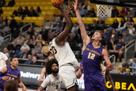 Long Beach State men's basketball junior forward Lassina Traore shoots a layup on a Cal Lutheran defender in the home opening game inside the Walter Pyramid. Traore led the Beach with 19 points and seven rebounds in the 107-63 win over the Kingsmen.