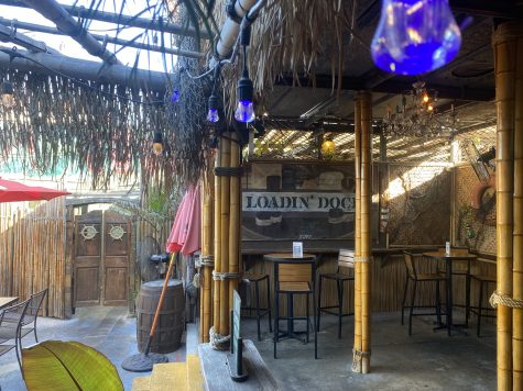 Part of Bamboo Club's outdoor patio decorated with nautical artwork and props.
