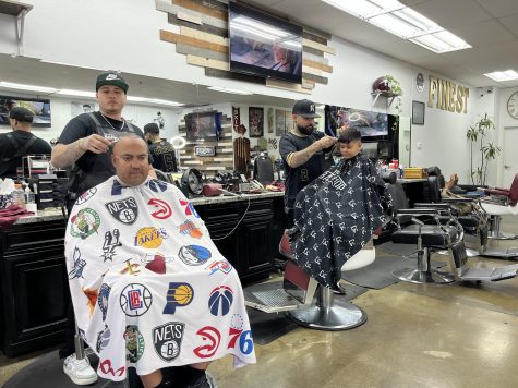 LA's Finest Barber Shop caters to clients from all age groups and they charge children under 13 at $25. Owner Ruben Magaña (right) is seen cutting a youngster’s hair during an early morning cut.