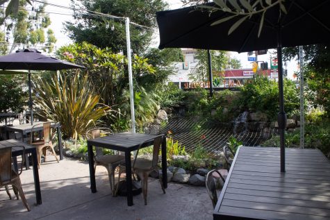 The outdoor patio offers plenty of scenery for customers' enjoyment with an array of plants and a pond full of fish.