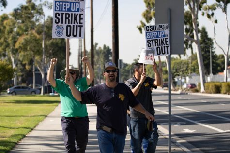 11/14/2023 Long Beach, Calif: Workers for the CSU Teamsters showed up at Cal State Long Beach to strike as they walked through E. Atherton St. and Merriam Way. Michael Harris (the person in the middle) is a Teamster 2010 union representative for CSULB and has been at CSULB for five years.