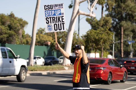 11/14/2023 Long Beach, Calif: Javier Moncayo walked around through E. Atherton St. as he showed the "CSU Unfair Labor" sign and got multiple honks from the local cars. Moncayo said that he felt great and that the strike shows the impact of how they can get together and make loud noise.