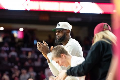 12/10/2023 - Los Angeles, Calif: Los Angeles Lakers forward Lebron James cheers for his son Bronny James Jr. as he makes his debut for the USC Trojans against Long Beach State inside the Galen Center.