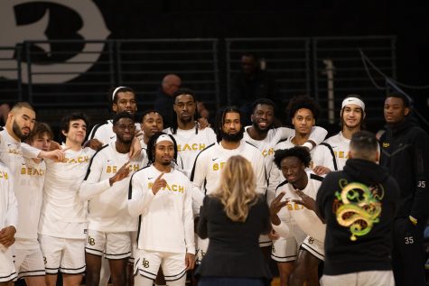 12/30/23 - Long Beach, Calif: Before the game tipped off, senior guard Marcus Tsohonis was celebrated for getting 1,000 total career points and he took photos with his Long Beach State teammates.