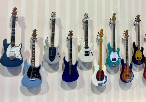 A colorful assortment of Sterling by Music Man guitars are displayed along the company's booth at NAMM on Saturday.
