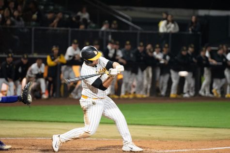 Long Beach State Dirtbags junior catcher Cole Santander swings the bat on a pitch against the University of Washington at Blair Field. Santander went 2-5 from the plate and scored one run as the Dirtbags beat the Huskies 10-5 in the home-opener.